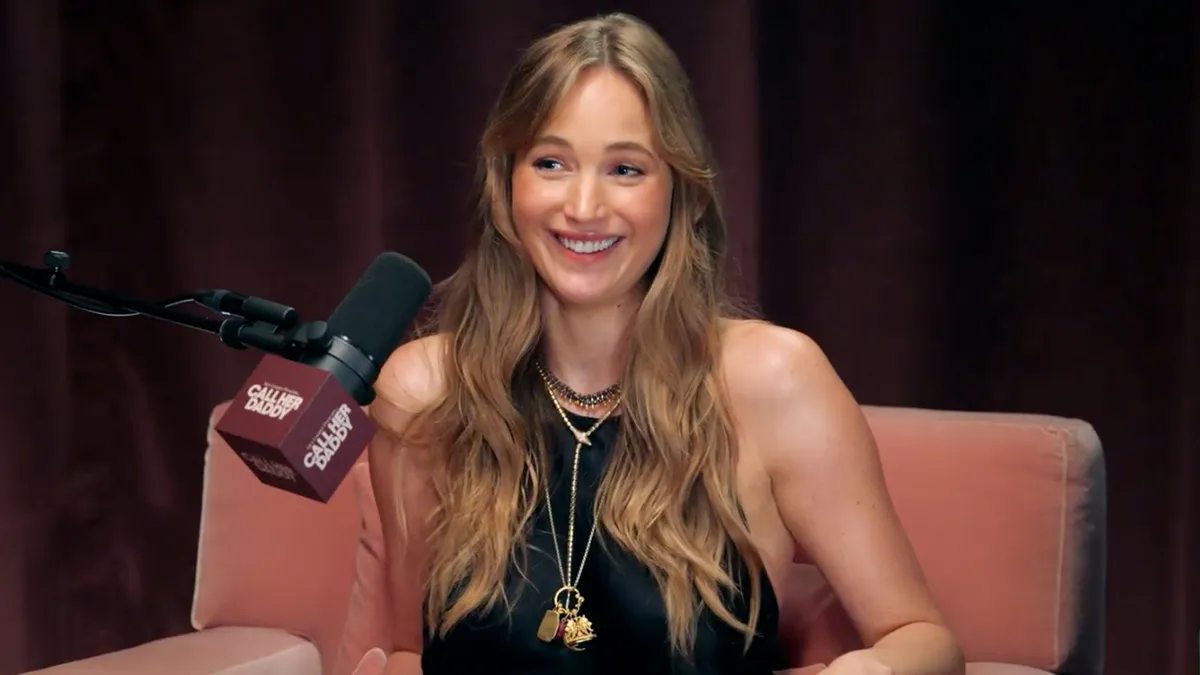 Jennifer Lawrence smiling at a red carpet event.