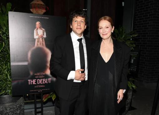 Jesse Eisenberg and Julianne Moore smiling together at a film premiere event.