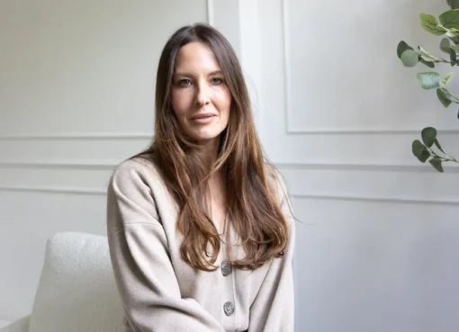 Lauren Winslade, founder of Aisle 8, smiling professionally in a stylish setting.