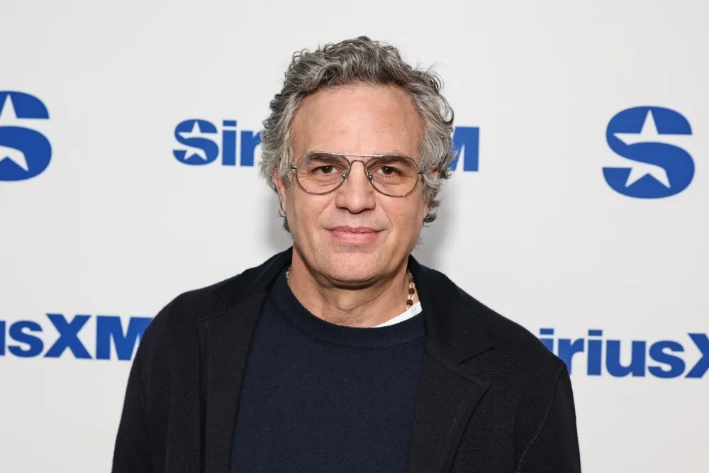 Mark Ruffalo looking concerned and speaking into a microphone.