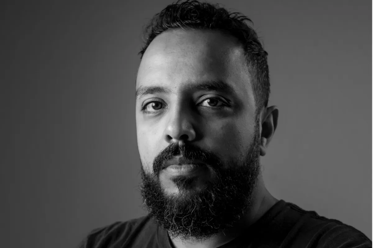 Mohamed Kordofani, a Sudanese filmmaker, looking thoughtful and engaged.