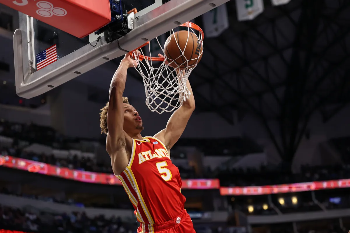A basketball game in action on a screen.