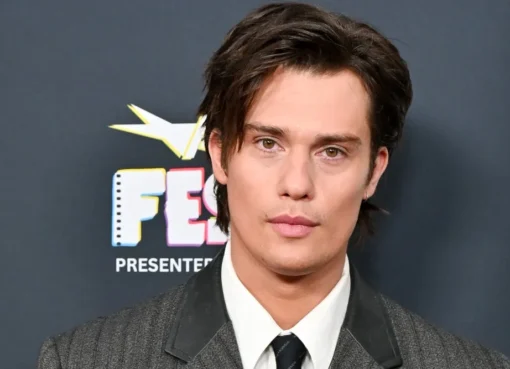 Nicholas Galitzine smiling at a premiere, looking dapper.