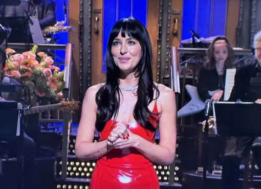 Taylor Swift and Dakota Johnson laughing on stage during SNL.