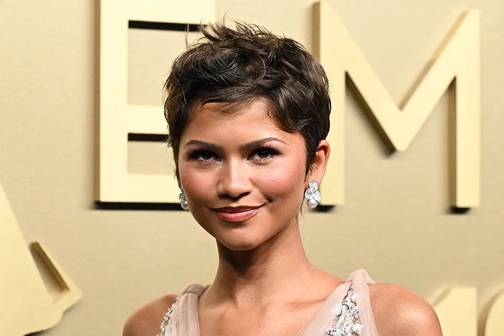 Zendaya posing confidently, possibly in a sleek, modern outfit.