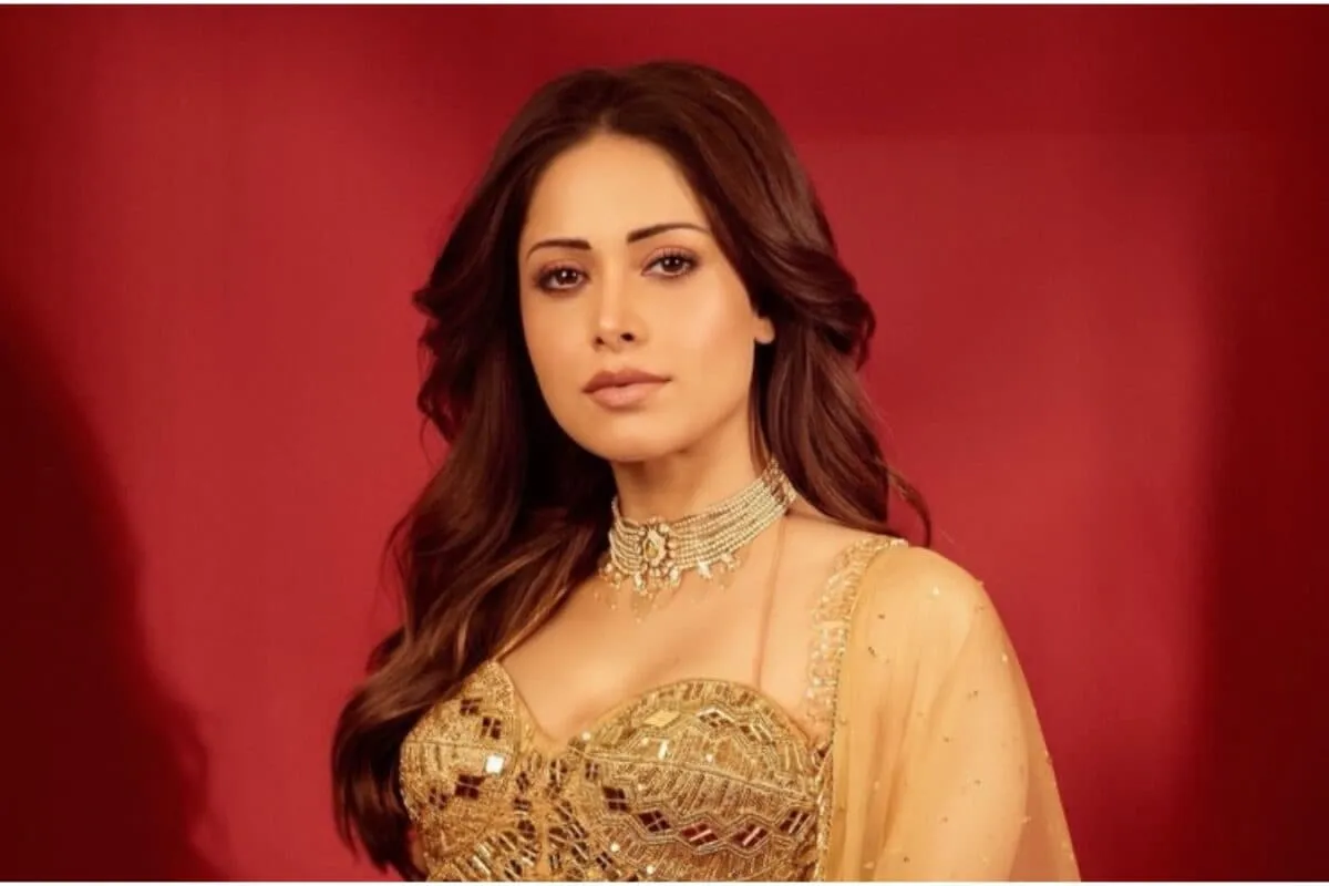 Nushrratt Bharuccha smiling brightly in a promotional photo.