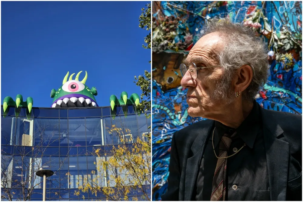 Tony Kaye standing among large, colorful monster sculptures in Leicester.