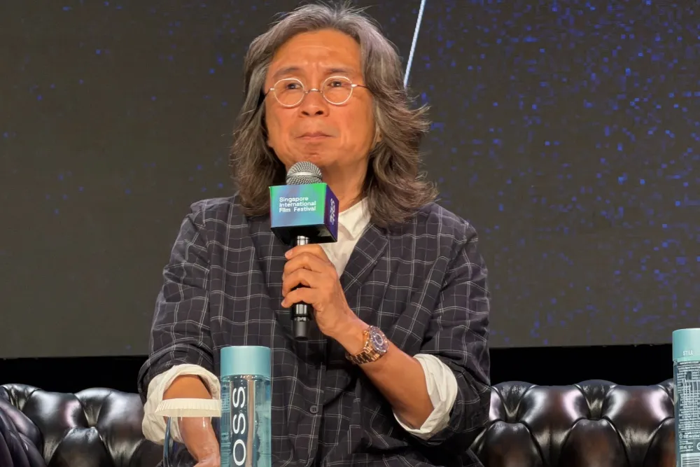 Acclaimed Asian filmmaker Peter Chan Ho-sun smiling warmly.