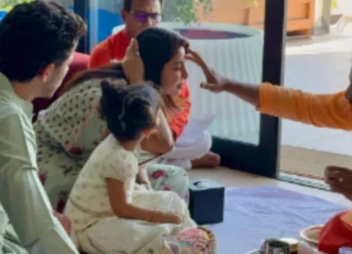 Priyanka Chopra and Nick Jonas sitting with daughter Malti during a traditional Kanya Pujan ceremony.