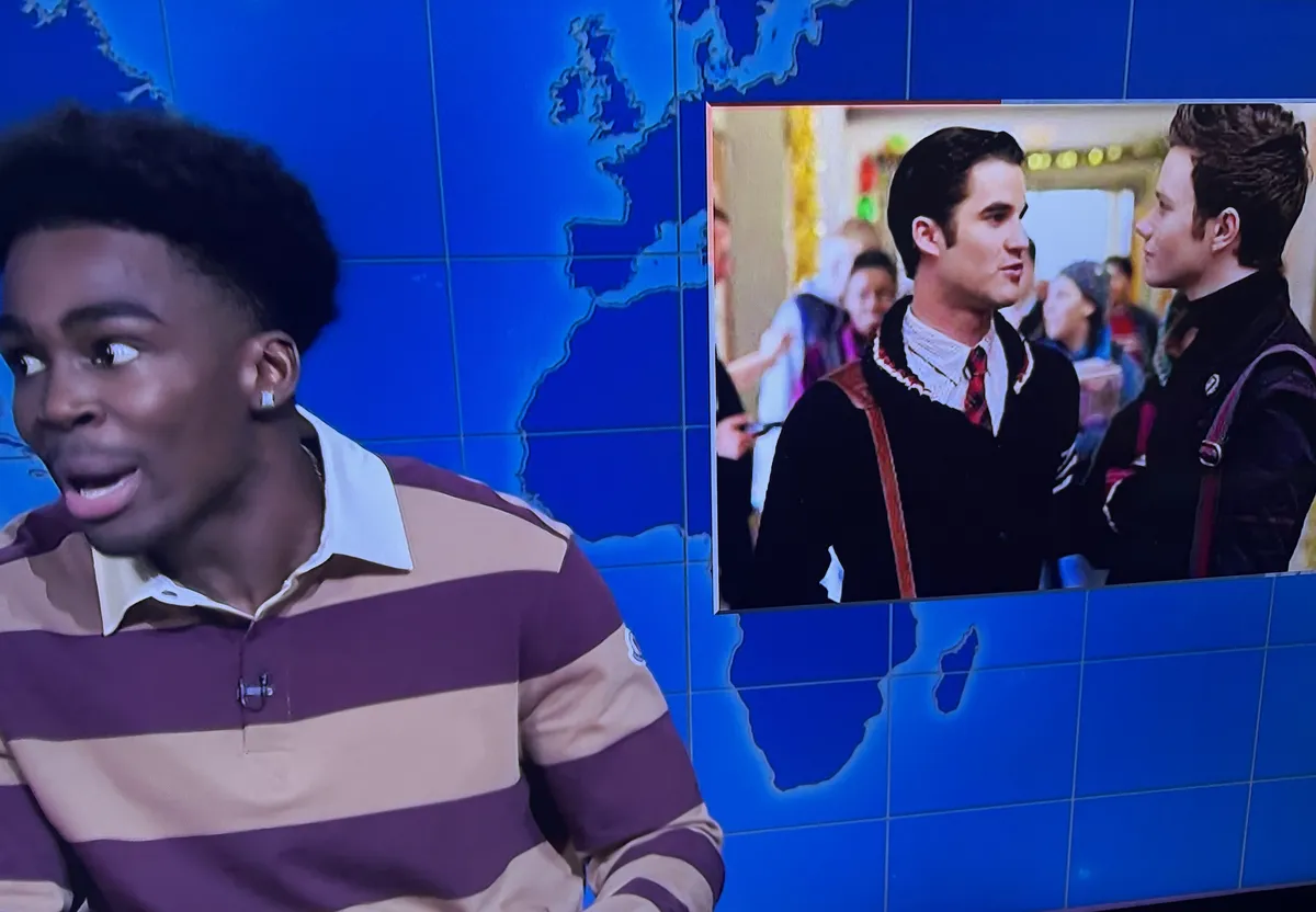 Michael Che on the Weekend Update desk, looking serious.