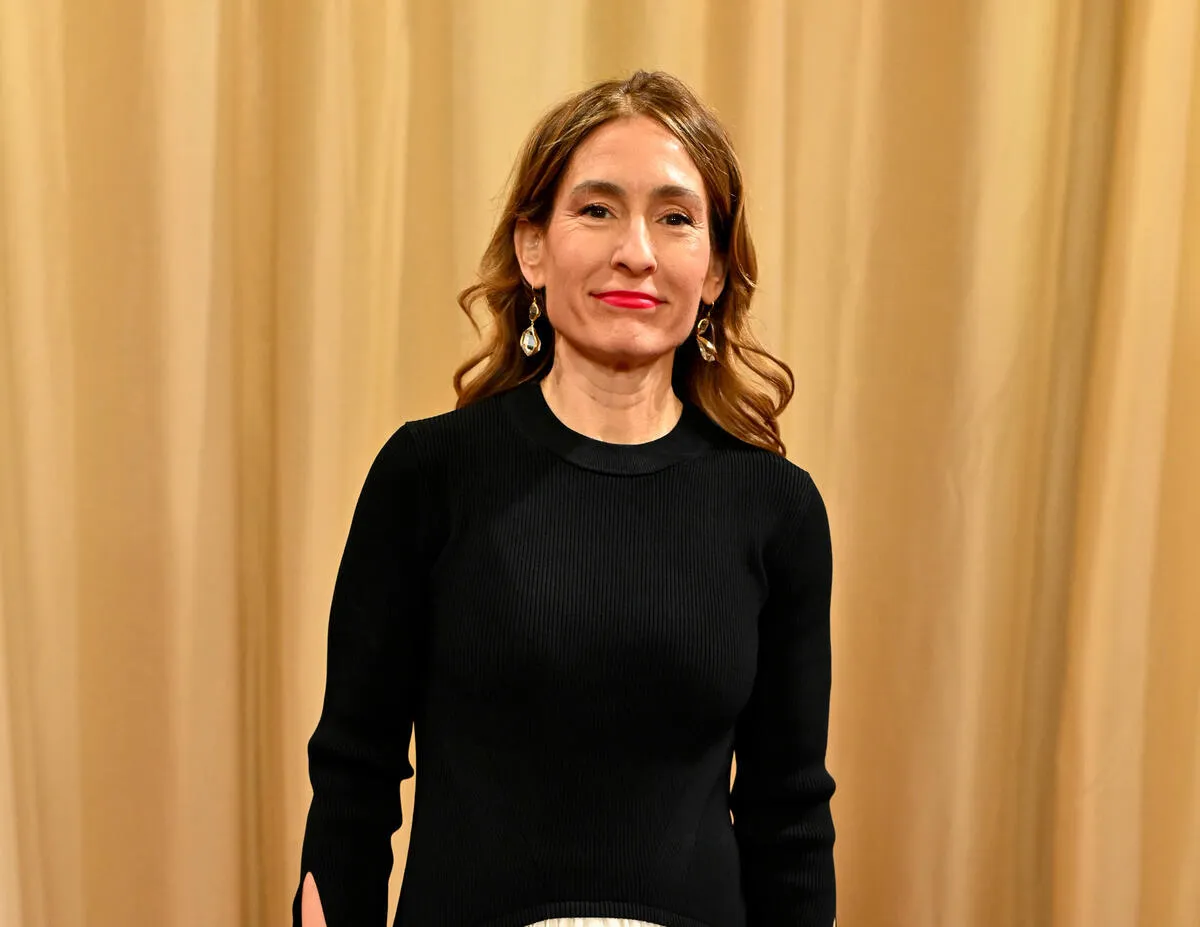 Michelle Hooper, a woman with a warm smile, posing for a professional headshot.