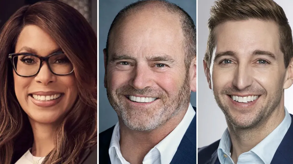A modern office with bright lights and logos of television studios.