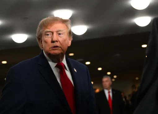 Donald Trump speaking at a podium.