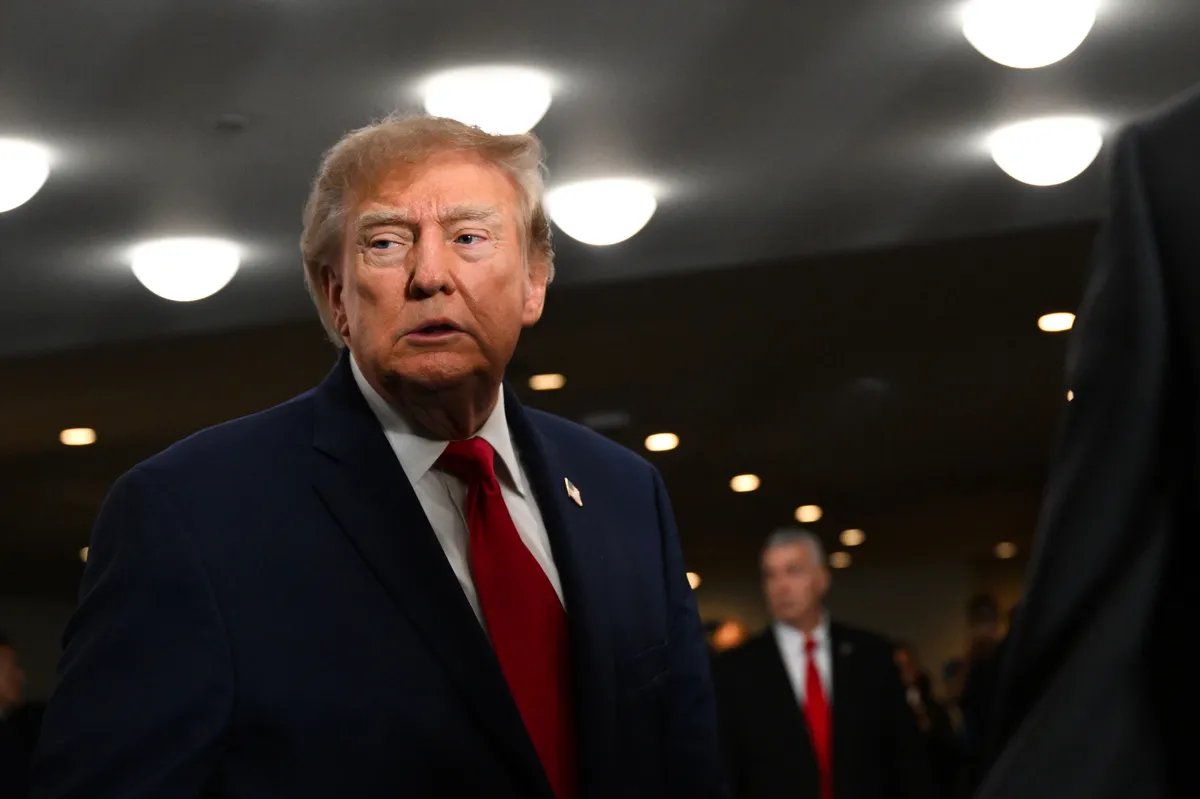 Donald Trump speaking at a podium.