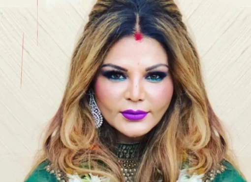 Rakhi Sawant looking dramatic on a reality TV set.