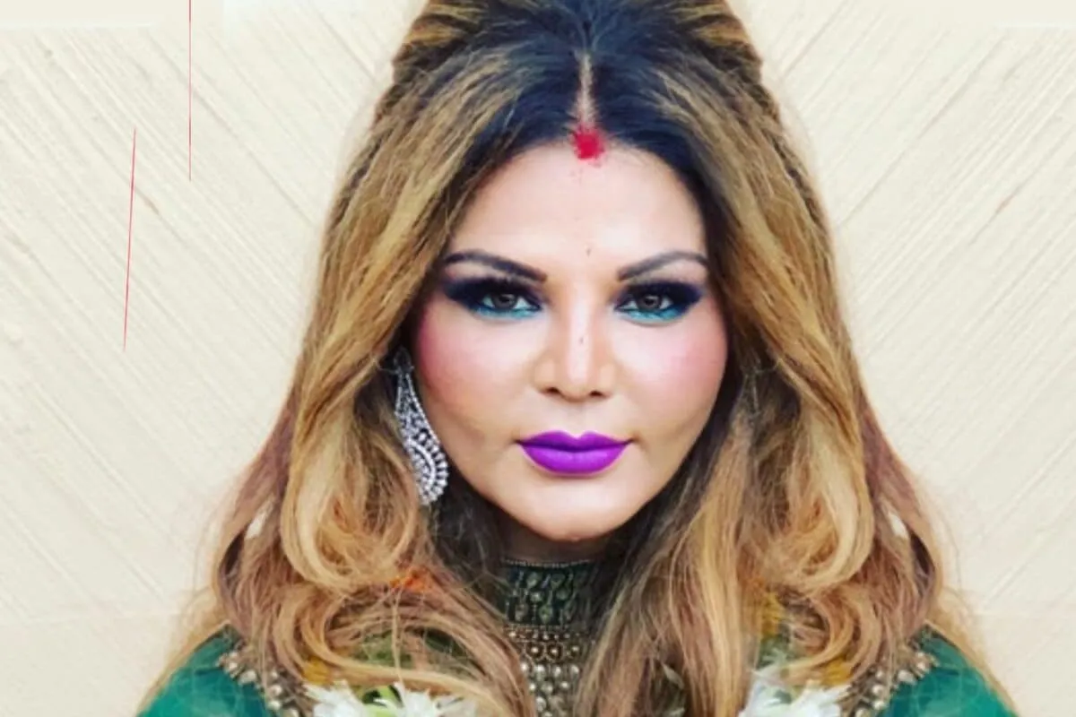 Rakhi Sawant looking dramatic on a reality TV set.