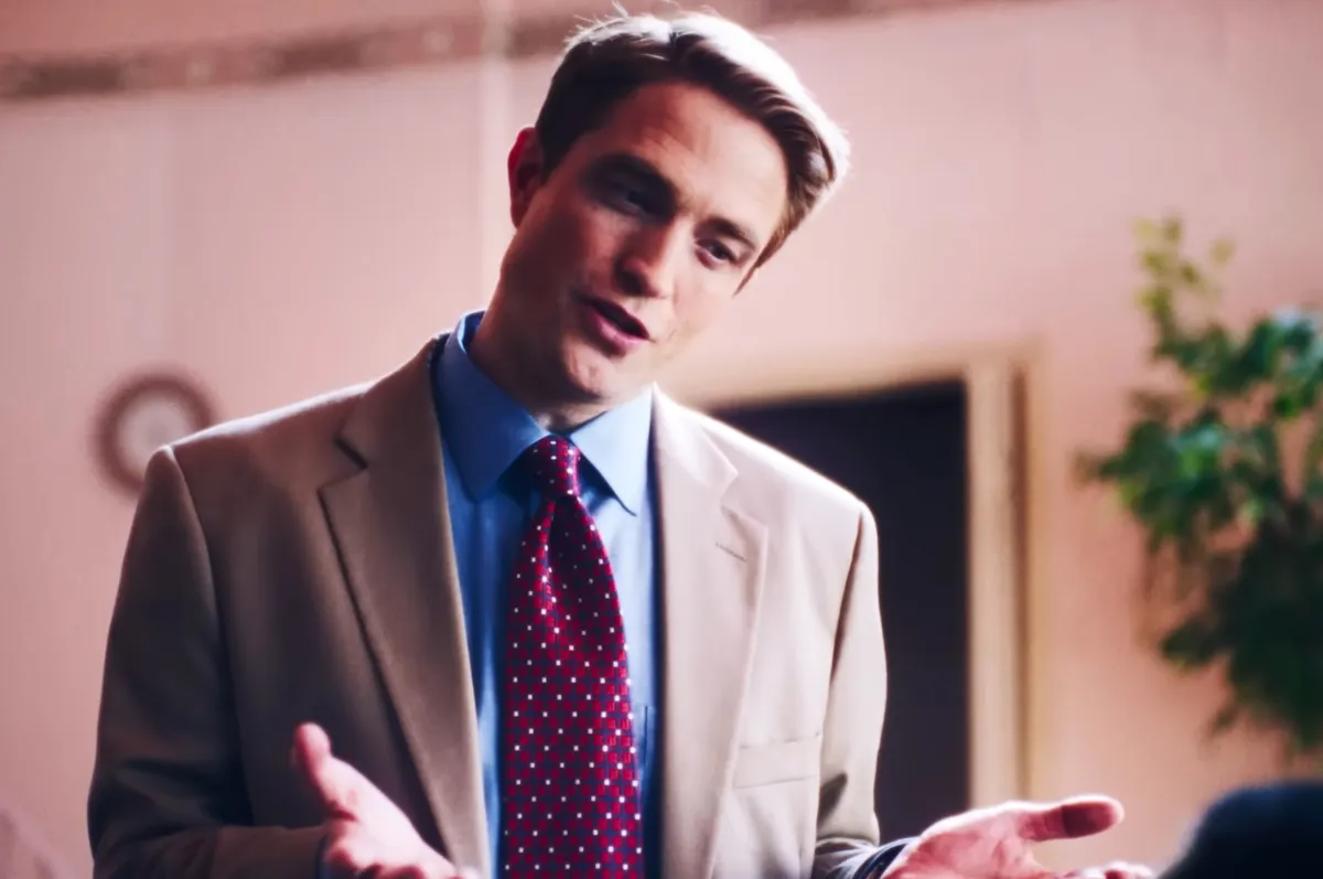 Robert Pattinson looking serious, holding a Zyn canister with the 'Dear Chris Han-Zyn' note.