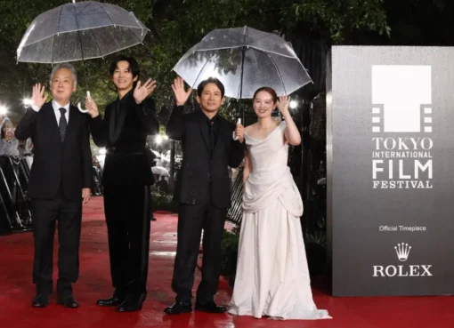 Director Zeze Takahisa smiling at a film festival.