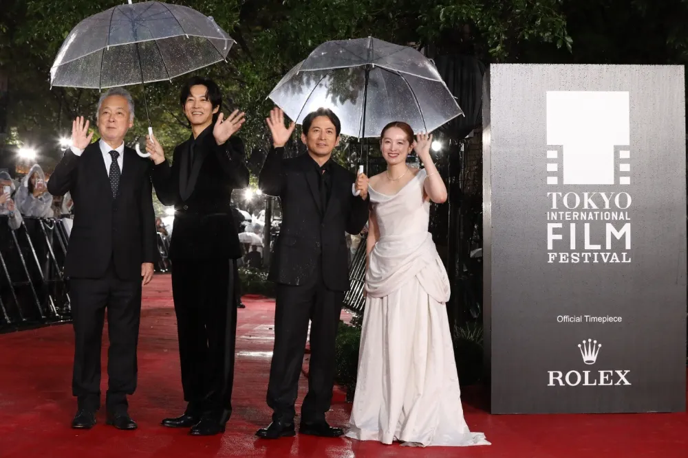Director Zeze Takahisa smiling at a film festival.