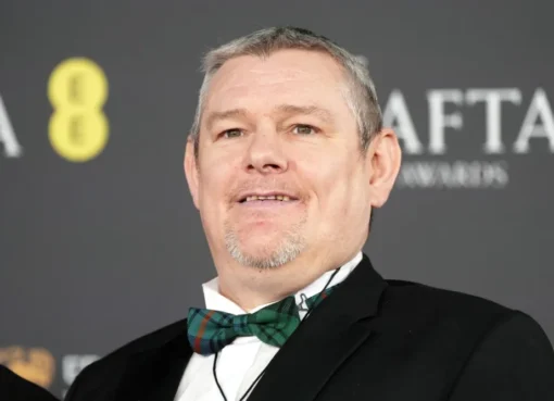 John Davidson, a man with Tourette's, in a formal setting or at an event.