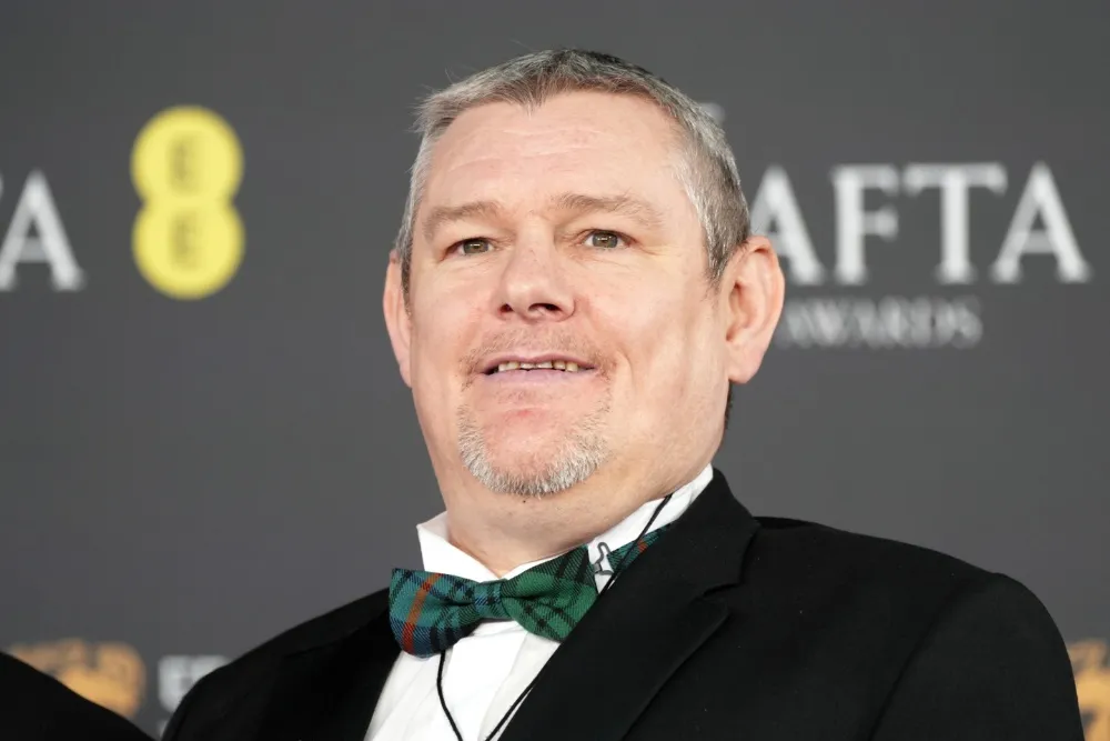 John Davidson, a man with Tourette's, in a formal setting or at an event.