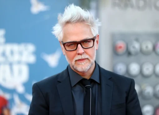 James Gunn smiling and looking thoughtful, possibly envisioning new film ideas.