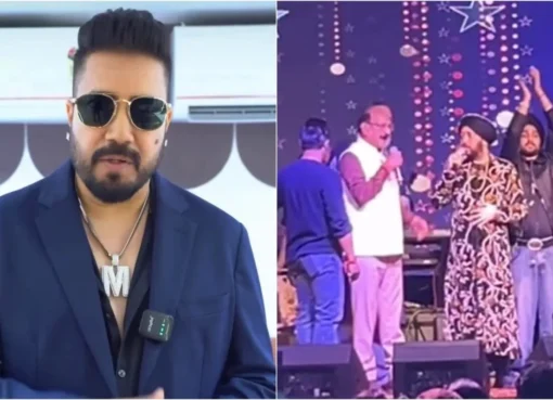 Daler Mehndi singing on stage under bright concert lights, surrounded by a vibrant crowd.