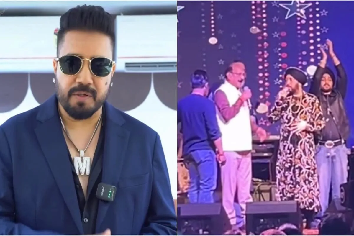 Daler Mehndi singing on stage under bright concert lights, surrounded by a vibrant crowd.