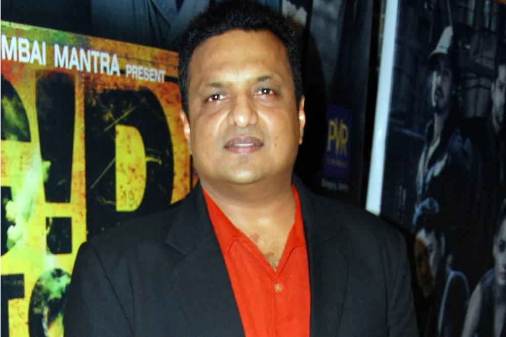 Indian filmmaker Sanjay Gupta smiles during an event.
