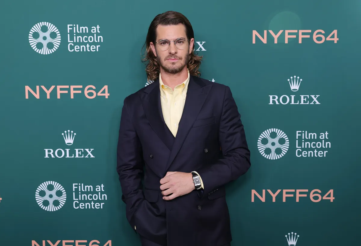 Andrew Garfield looking serious and thoughtful, possibly with a subtle AI-themed background.