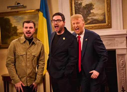 Donald Trump impersonator on a TV show stage.