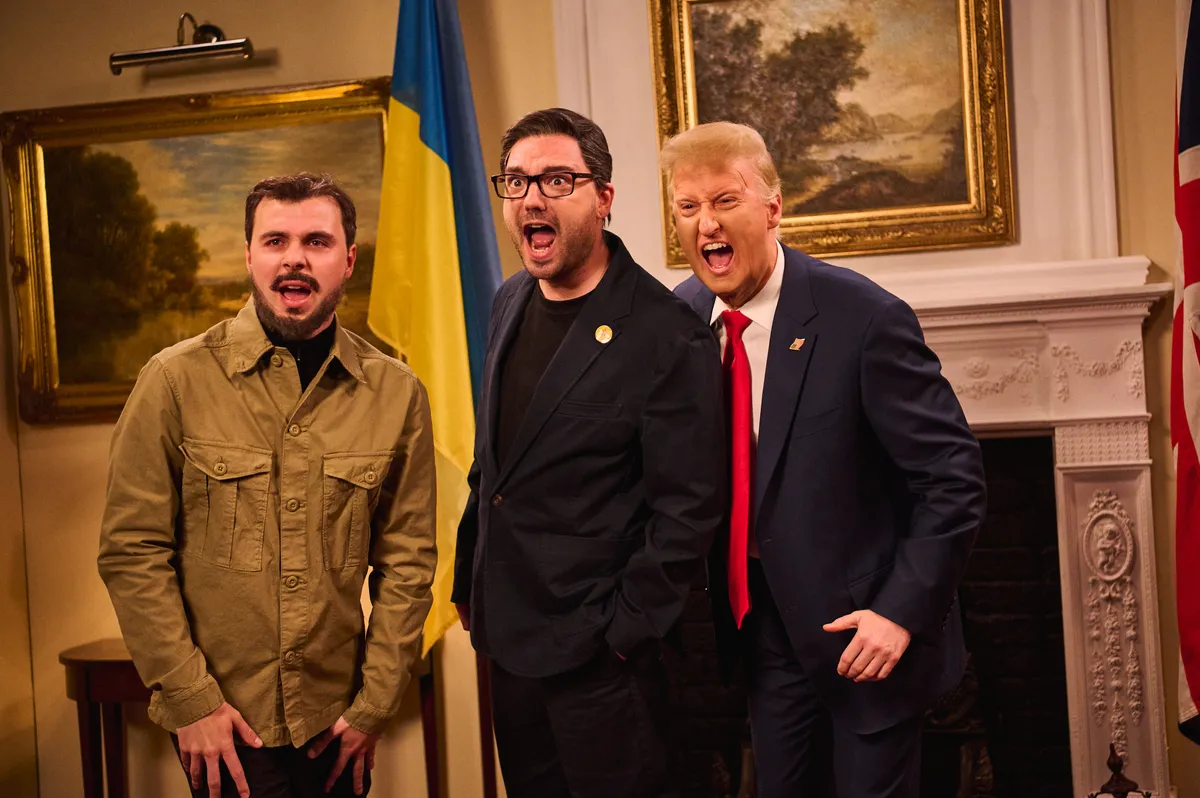 Donald Trump impersonator on a TV show stage.