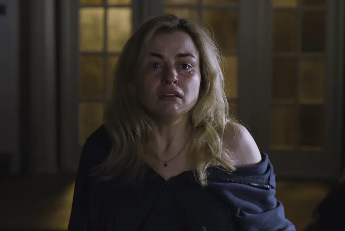 A dark and mysterious still image from a horror film.