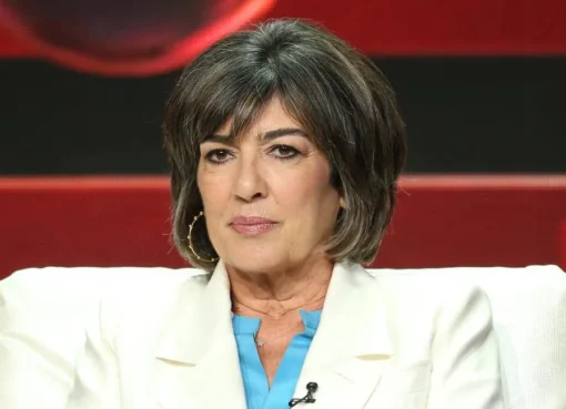 Christiane Amanpour reporting from a conflict zone with a serious expression.