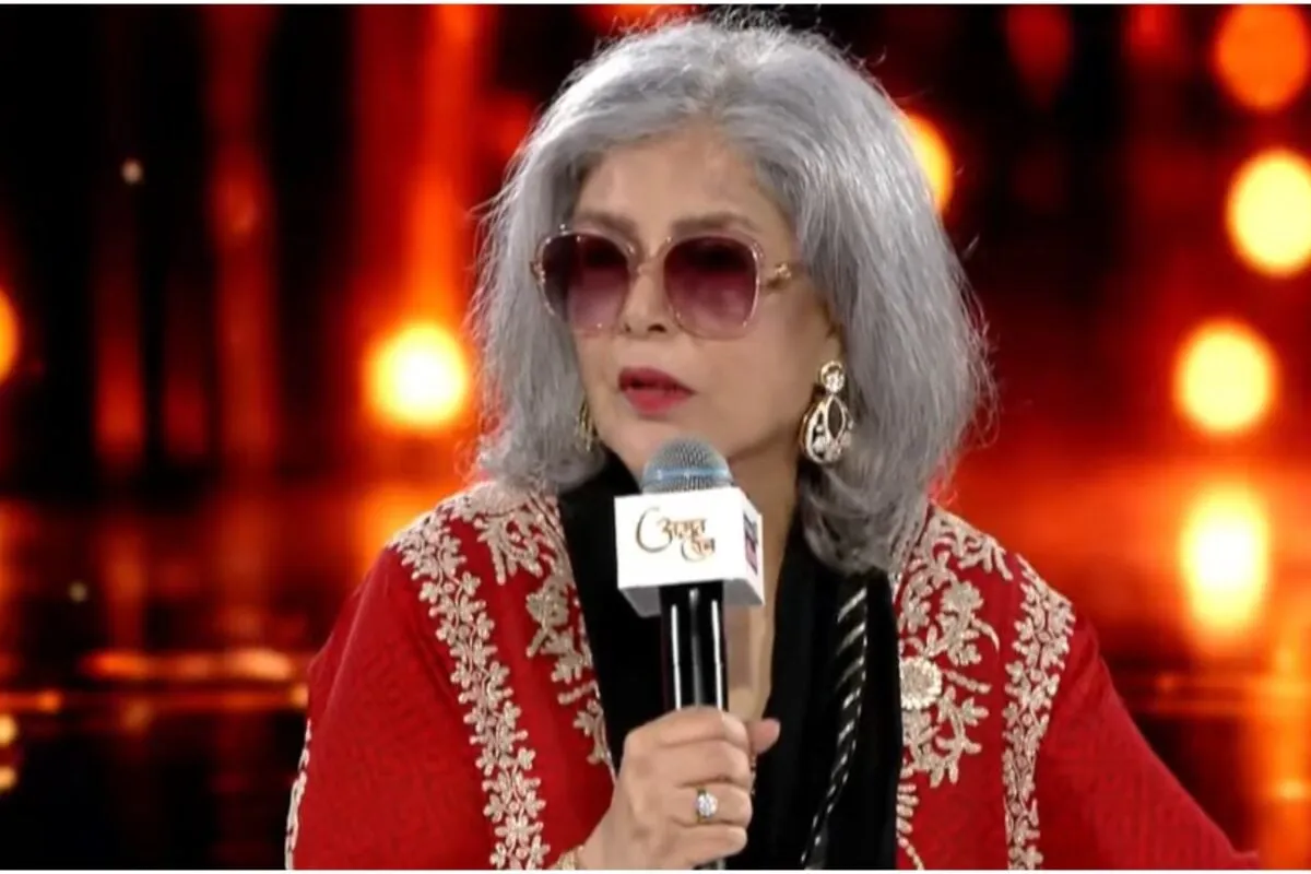 Zeenat Aman smiling elegantly, looking confident.